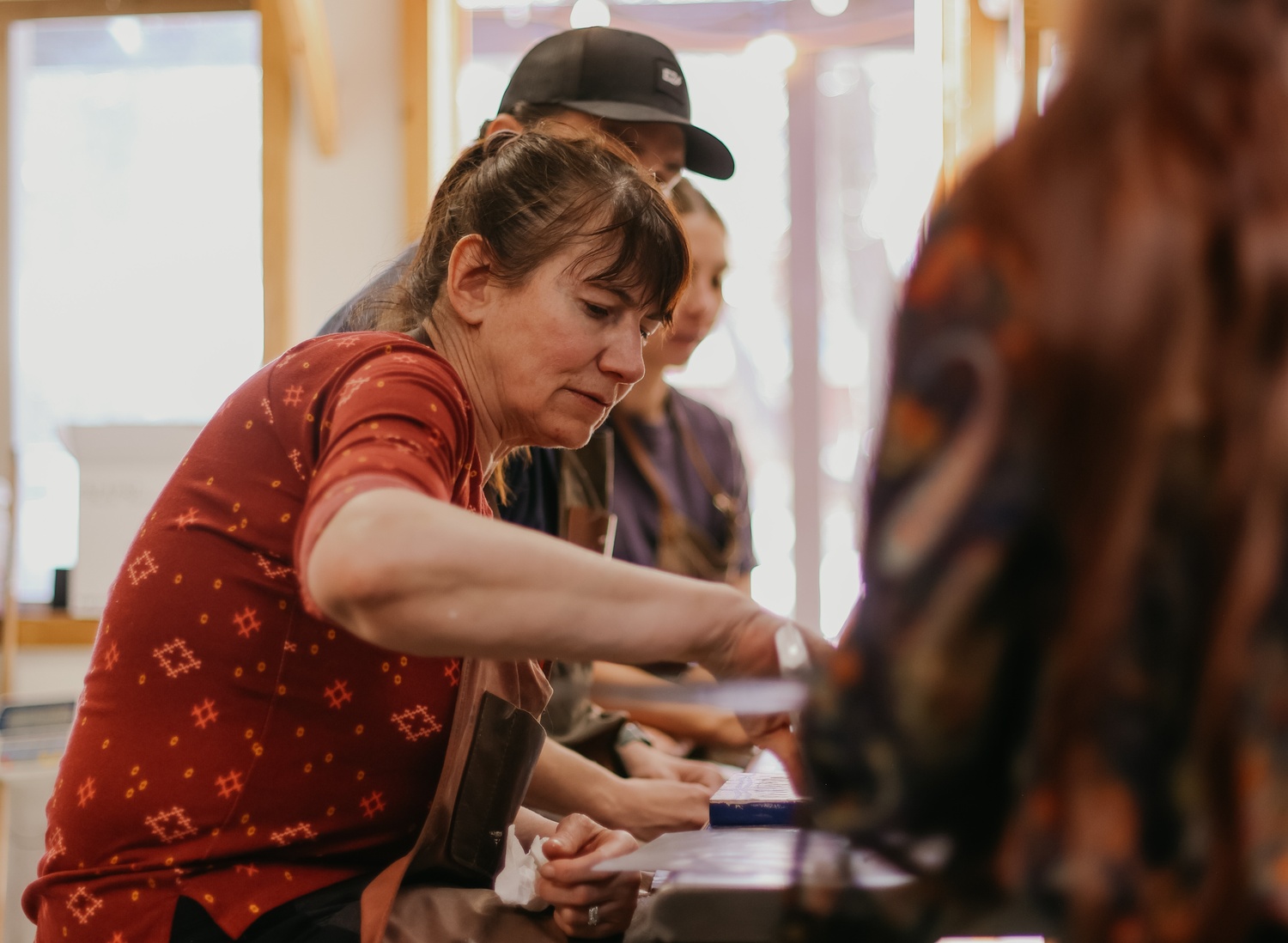 woman sitting at table painting